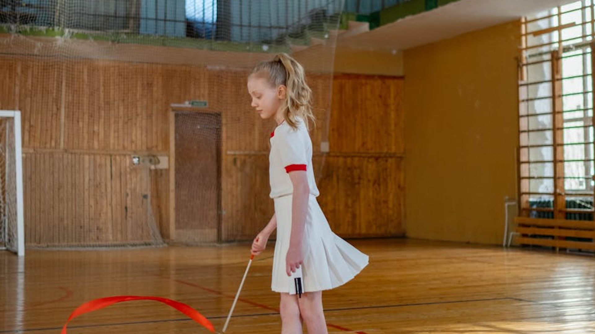 Active woman practicing graceful movements in a modern gym